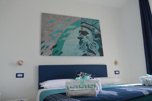 a bedroom with two beds and a painting on the wall at VistAmare - Fuscaldo in Marina di Fuscaldo