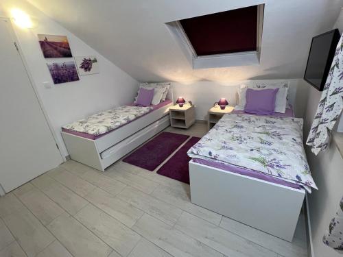 a small room with two beds and a tv at Apt Bobotovi in center of Stari Grad, Hvar in Stari Grad