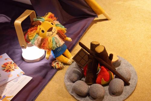 a stuffed lion toy sitting on top of a blanket at The Ritz-Carlton Shanghai, Pudong in Shanghai