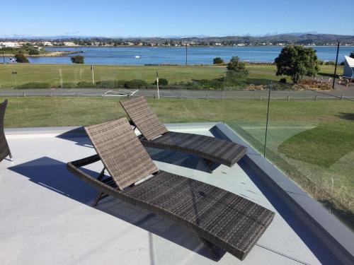 two wicker chairs sitting on top of a slide at East Pier Hotel in Napier