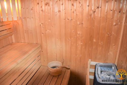 a sauna with a tub and a bucket in it at Adonis Grandcamp - Résidence Les Isles De Sola in Grandcamp-Maisy