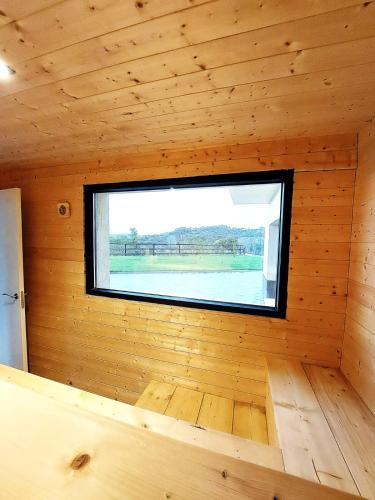 a room with a window in a wooden cabin at Las vistas del valle in Hontoba