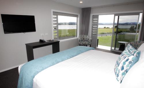 a hotel room with a bed and a television at East Pier Hotel in Napier
