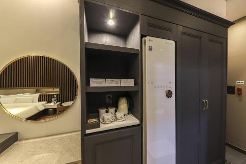 a bathroom with a mirror and a sink and a door at Hotel Demer Mokpo in Mokpo