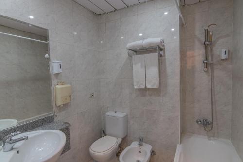 a bathroom with a sink and a toilet and a shower at Dexon Roma Hotel in Hurghada