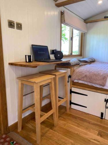 a small room with a desk with a laptop on it at The Hereford Hut, Charming 1 bedroom Shepherds Hut in Callow