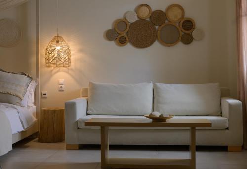 a living room with a couch and a table at Oikies Small Elegant Houses in Mytilini