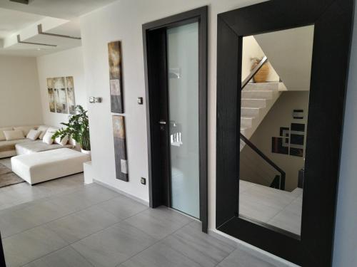 a black door in a living room with a staircase at Private Family Villa in Budaörs