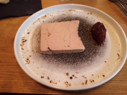 a white plate with a piece of food on a table at le logis gourmand a Payroux in Payroux