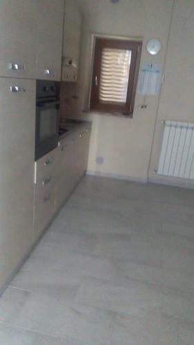 an empty kitchen with a window in a room at Casa Vacanze Zia Maria in Montegiordano