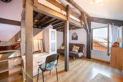 a room with a loft bed and a couch at Chez Malou & Hugo vue lac proche Suisse & stations ! in Saint-Gingolph