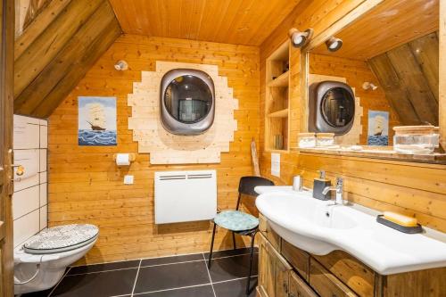 a bathroom with a sink and a toilet and a window at Chez Malou & Hugo vue lac proche Suisse & stations ! in Saint-Gingolph
