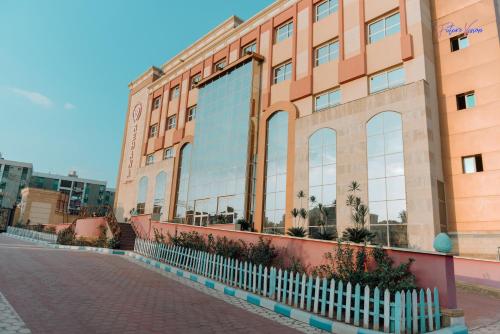 a building with a fence in front of it at Rehana Plaza Hotel in Cairo