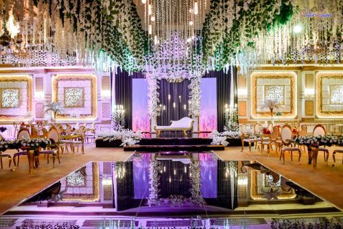 a banquet hall with tables and chairs and a chandelier at Rehana Plaza Hotel in Cairo