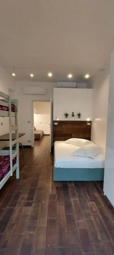 a bedroom with a bed and two bunk beds at LittleAndCosy in Turin