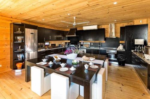 a kitchen with a large island in the middle at A Casa do Tio Tenente - Casa Toda in Ermida