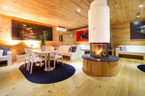 a living room with a table and a fireplace at A Casa do Tio Tenente - Casa Toda in Ermida