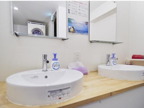 a bathroom with a white sink and a mirror at Osaka guest house sakura / Vacation STAY 2409 in Osaka