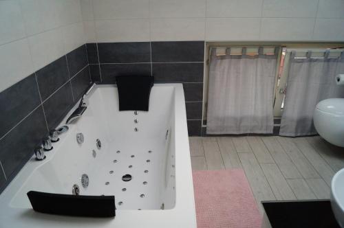 y baño con bañera, aseo y lavamanos. en Charme Lake Loft, en Ispra