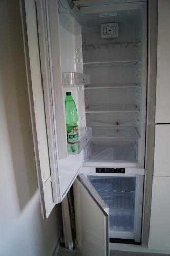 a bottle of water sitting inside of an empty refrigerator at Charme Lake Loft in Ispra