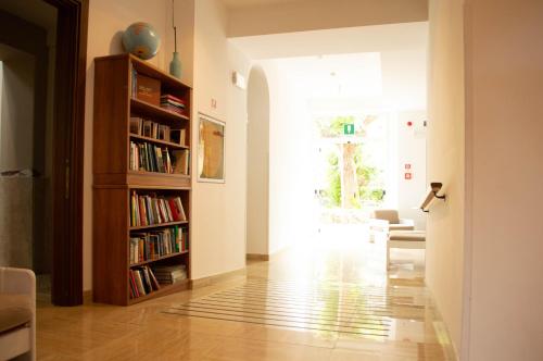 a hallway with a book shelf and a living room at Villa Riari Garden in Rome
