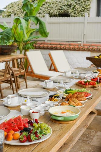 a wooden table with plates of food on it at Anıt Konak in Alaçatı