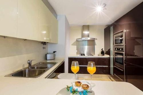 a kitchen with two wine glasses on a counter at My Chiado Suite in Lisbon