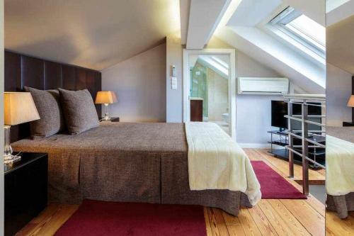 a bedroom with a large bed in a attic at My Chiado Suite in Lisbon