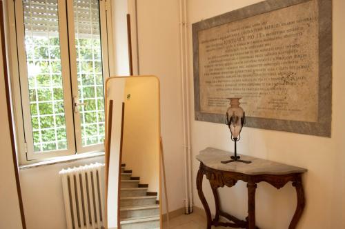a room with a table and a refrigerator and a window at Villa Riari Garden in Rome