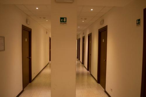 an empty hallway of a building with two doors at Villa Riari Garden in Rome