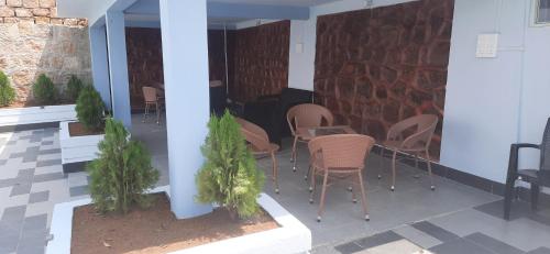 a group of chairs and tables on a patio at The Arcadia Pool and Villa - Umroi in Shillong