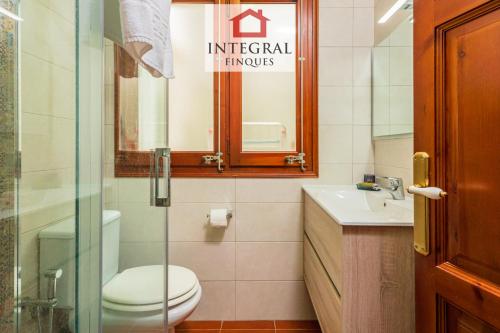 a bathroom with a toilet and a sink at La Masia de la Fosca in Palamós