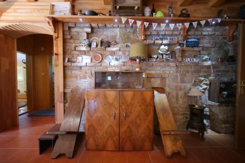 een keuken met een stenen muur met een bank en een tafel bij Villa Hota Sarajevo in Rakovica