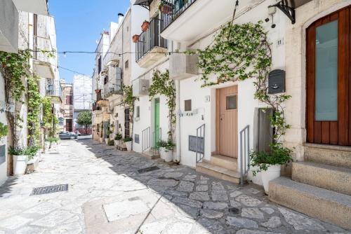 a street in an old town in malta at Vico di Ostuni Apartments by Rentbeat in Ostuni