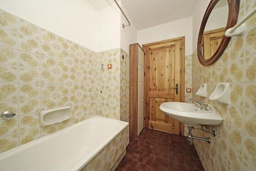 a bathroom with a bath tub and a sink at Residenza CRB 38 by Wonderful Italy in Manerba del Garda