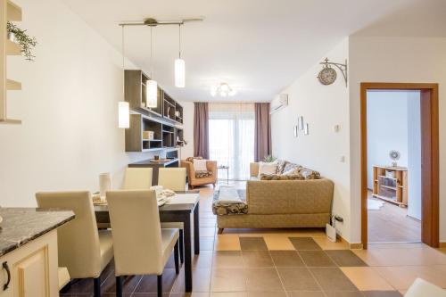 a kitchen and living room with a table and chairs at My Old Family Home (with parking near centre) in Budapest