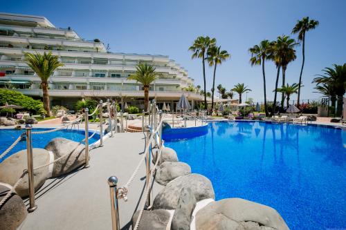 una grande piscina con un hotel sullo sfondo di Estudio Altamira 128 - Tenerife ad Adeje