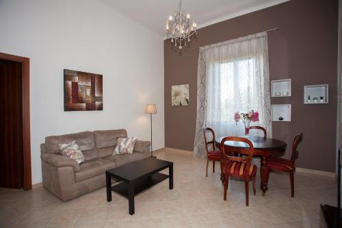 a living room with a couch and a table at Casa Dafne in Livorno