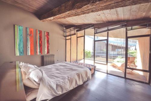 une chambre avec un lit et une grande fenêtre dans l'établissement Splendide Chai 700 m2 Bordeaux, à Bordeaux