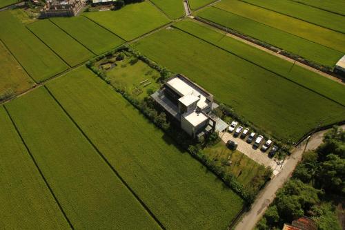 an aerial view of a farm with a truck in a field at 輕塵別院Serenegray B&B in Wujie