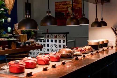a buffet line with pots and pans on a counter at Salinda Resort Phu Quoc - Sparkling Wine Breakfast in Phu Quoc