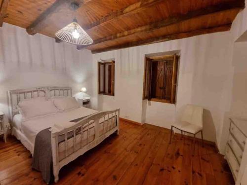 a bedroom with a large bed and a wooden floor at Casadimela in Mela