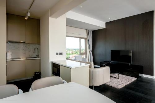 a room with a kitchen and a living room at Riverfront Apartments Vientiane in Vientiane