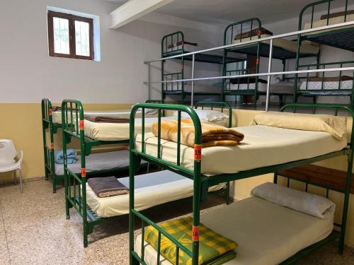 a group of bunk beds in a room at Albergue municipal in San Martín del Camino