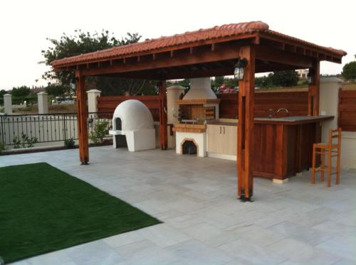 a pavilion with a kitchen and a grill at Eagles Cliff Villa in Kathikas