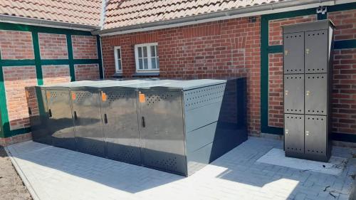 a brick building with two metal stalls in front of it at Ferienhotel Alter Bahnhof garni in Prerow