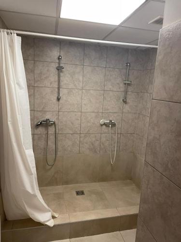 a bathroom with a shower with a shower curtain at Viola Hostel in Budapest