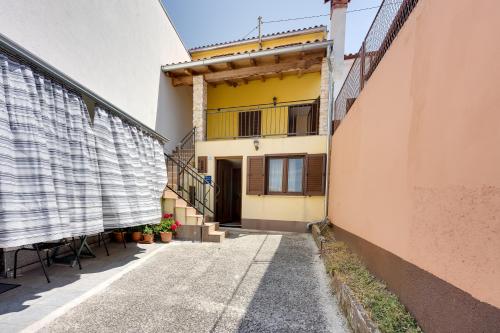 a walkway between two buildings with a yellow house at Holiday Home Ema - Happy Rentals in Vabriga