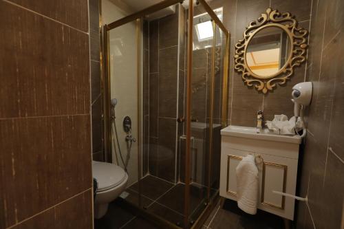 W łazience znajduje się prysznic, toaleta i lustro. w obiekcie GARDEN OTEL AMASYA w mieście Amasya