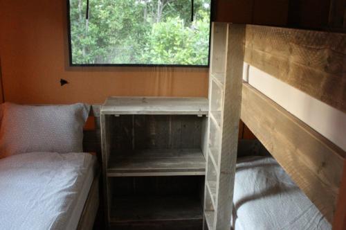 a bedroom with two bunk beds and a window at Camping Campo dei Fiori - Glamping4all in Vada